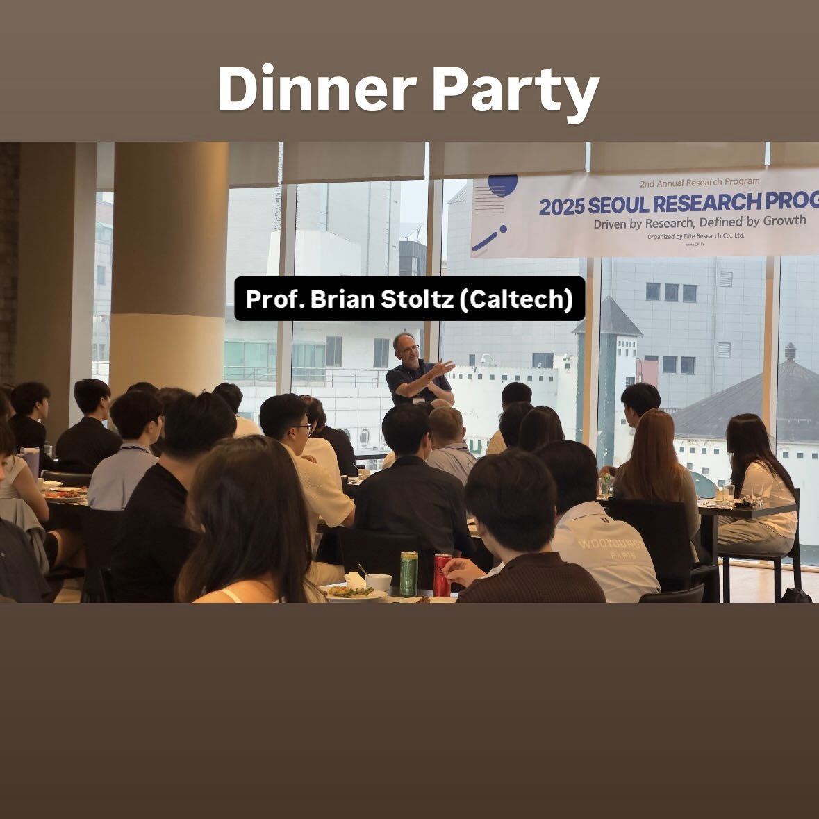 A professor speaks to a room of students seated at dinner tables beneath a 2025 Seoul Research Program banner