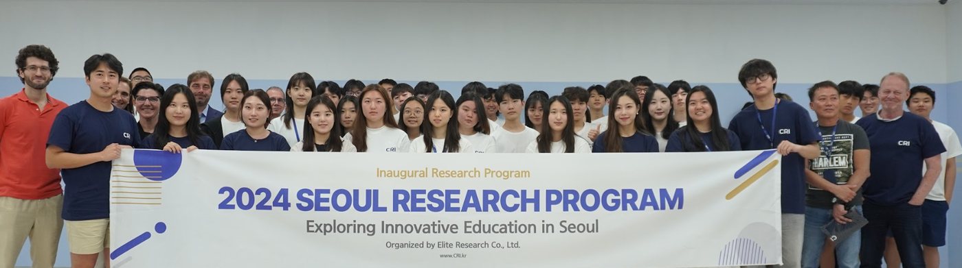A large group of students and faculty pose behind a banner reading "2024 Seoul Research Program: Exploring Innovative Education in Seoul"